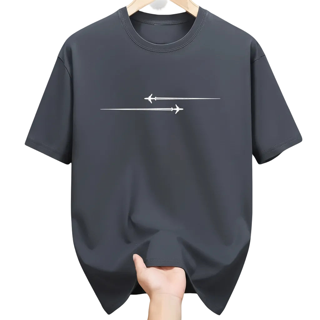 Black t-shirt with white airplane design held in a clothing store.