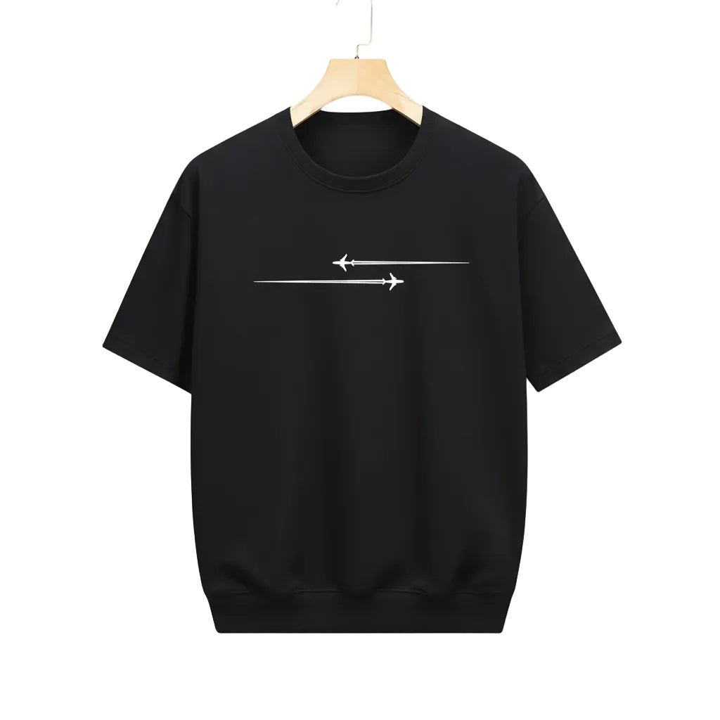 Black t-shirt with white airplane design on a hanger in a clothing store.