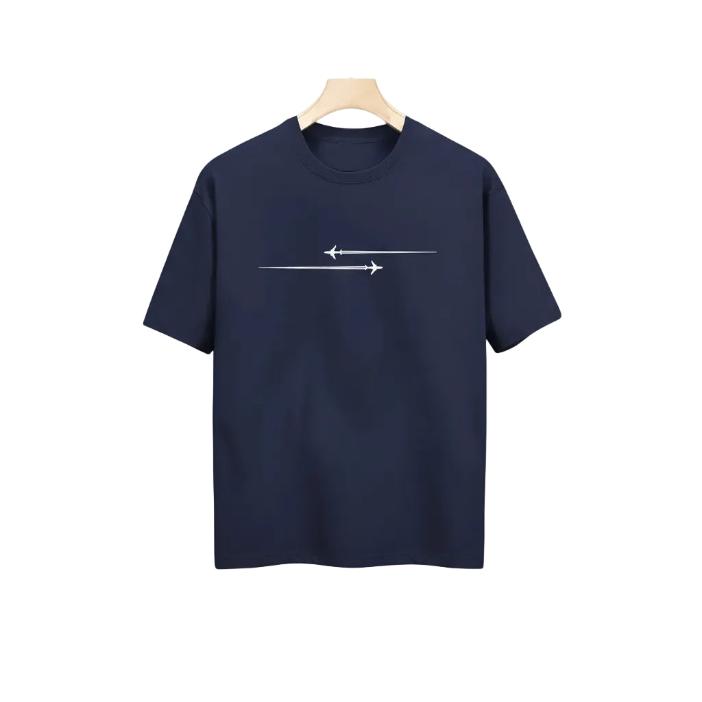 Navy blue t-shirt with white graphic design held in a clothing store.