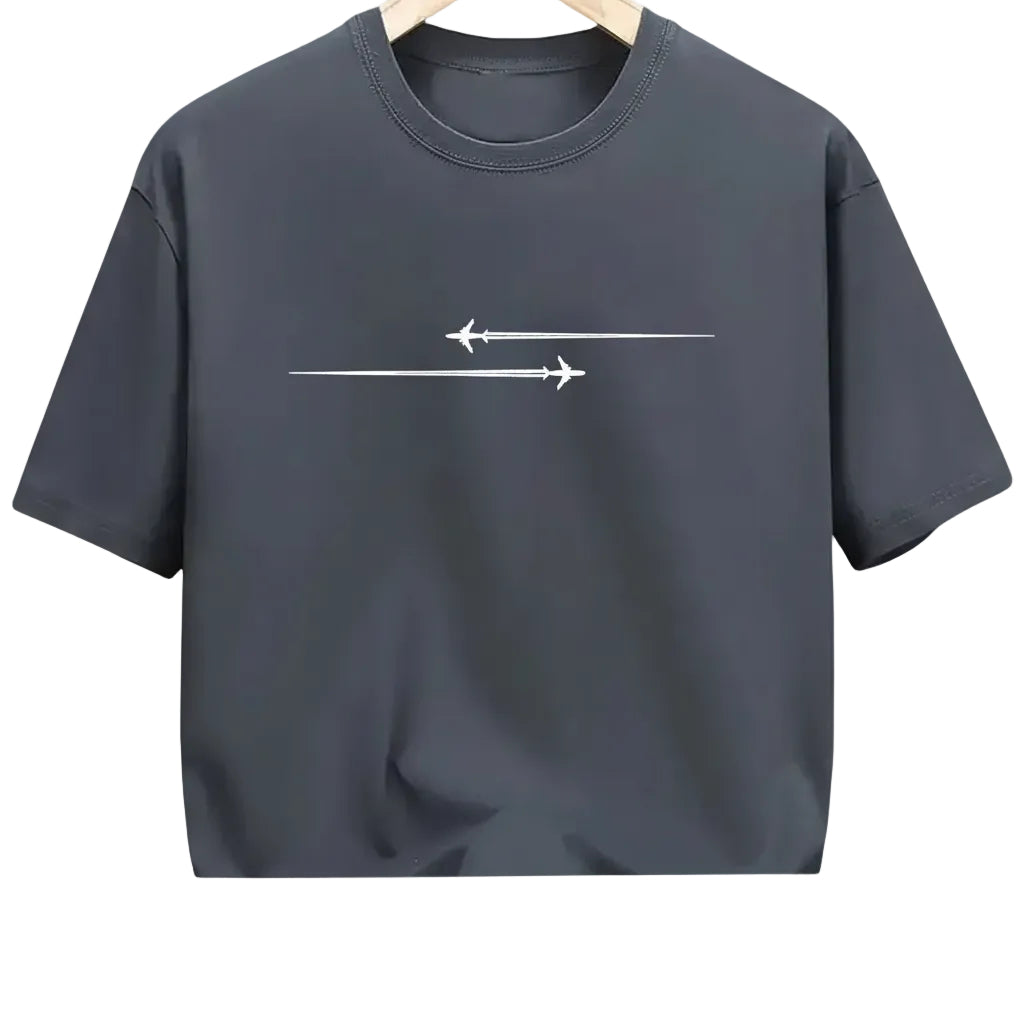 Black t-shirt with white airplane design held in a clothing store.