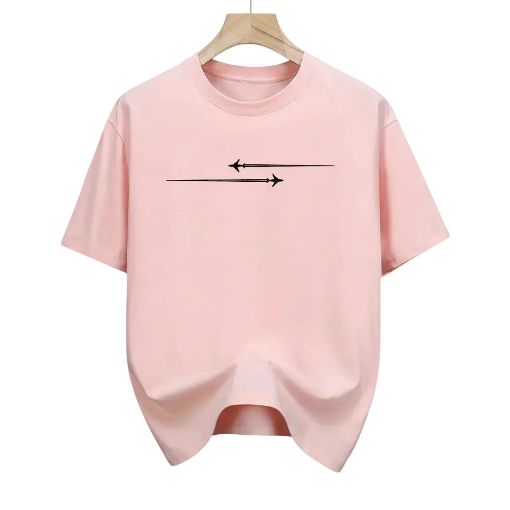 Pink t-shirt with black arrow design hanging in a store.