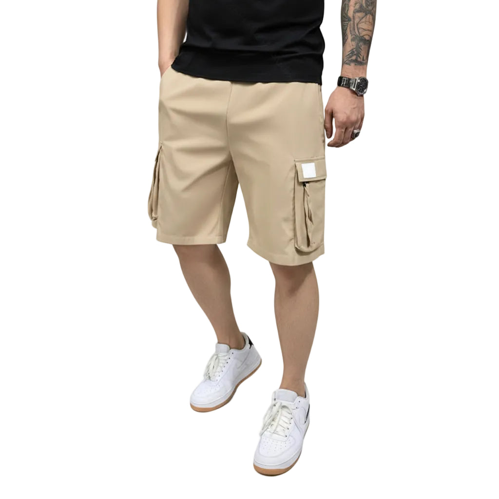 Person wearing beige cargo shorts with a plain background